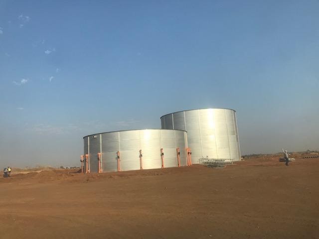 Strong winds prevented steel tank construction. Tank to the right is completed.
